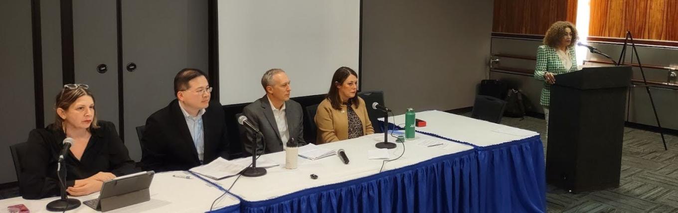 Photo of the panelists sitting behind a table