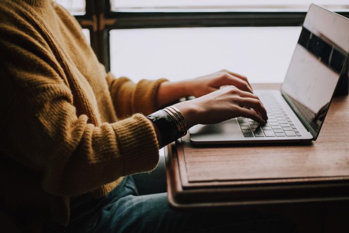 Photo of person typing by Christin Hume on Unsplash