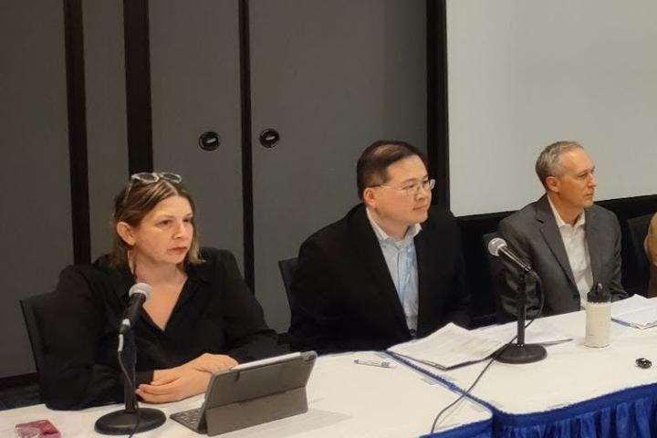 Photo of the panelists sitting behind a table