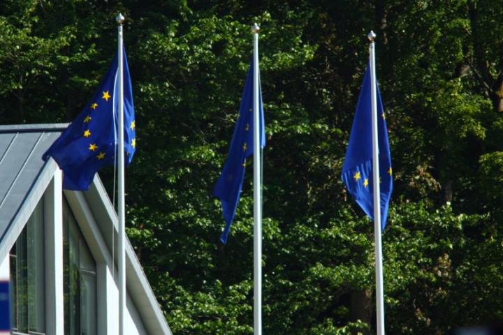 Three European Union flags fly from flagpoles