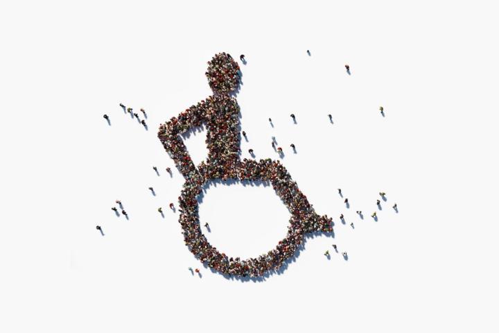 overhead view of crowd standing in shape of International Symbol of Access
